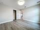A view of the bright bedroom with wood-look floors, fresh paint, and closet at 404 Wilshire Dr, Casselberry, FL 32707