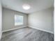A bright bedroom featuring wood-look floors, fresh paint, and natural light from the window at 404 Wilshire Dr, Casselberry, FL 32707