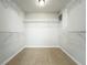 Walk-in closet with plenty of shelving and tile flooring at 404 Wilshire Dr, Casselberry, FL 32707
