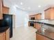 Spacious kitchen with stainless steel appliances, wood cabinets and tile flooring at 404 Wilshire Dr, Casselberry, FL 32707