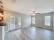 Open living room featuring new wood-look floors, natural light, and modern ceiling fan at 404 Wilshire Dr, Casselberry, FL 32707