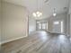 Spacious living room with gray flooring, arched doorways, multiple windows and elegant hanging chandeliers at 404 Wilshire Dr, Casselberry, FL 32707