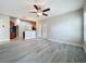 Open living room area featuring wood flooring and access to kitchen at 404 Wilshire Dr, Casselberry, FL 32707