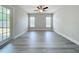Bright living room with wood flooring and exterior access door at 404 Wilshire Dr, Casselberry, FL 32707
