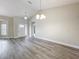 Light-filled living room showcasing gray flooring, high ceilings, and modern recessed lighting throughout at 404 Wilshire Dr, Casselberry, FL 32707