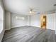 Inviting main bedroom featuring modern gray floors and a ceiling fan, creating a comfortable retreat at 404 Wilshire Dr, Casselberry, FL 32707