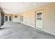 View of the covered patio with concrete flooring and entry to the house from the backyard at 404 Wilshire Dr, Casselberry, FL 32707