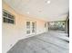 View of the covered patio with concrete flooring and entry to the backyard at 404 Wilshire Dr, Casselberry, FL 32707
