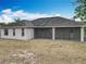 Rear exterior of the home showing the backyard, screened lanai and roofline at 404 Wilshire Dr, Casselberry, FL 32707