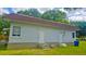 View of white brick back of home with brown roof and bright green grass at 412 Bay Nw St, Fort Meade, FL 33841