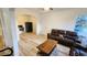Cozy living room featuring wood floors, an archway, and a leather sofa set at 412 Bay Nw St, Fort Meade, FL 33841