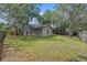 Fenced backyard showcasing a well-maintained lawn and mature trees with Spanish moss, offering privacy at 4161 Leafy Glade Pl, Casselberry, FL 32707