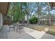 Outdoor patio area with a table and chairs, overlooking a lush green backyard with mature trees at 4161 Leafy Glade Pl, Casselberry, FL 32707