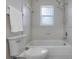 Bathroom with tiled walls, toilet, and bathtub featuring showerhead, soap holder, and towel rack at 4161 Leafy Glade Pl, Casselberry, FL 32707