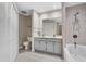 Bright bathroom featuring a double vanity, soaking tub, and tiled shower with modern finishes at 4161 Leafy Glade Pl, Casselberry, FL 32707