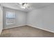Neutral bedroom with light-colored carpet and natural lighting from a large window at 4161 Leafy Glade Pl, Casselberry, FL 32707
