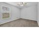 Bedroom with carpet and a window featuring a ceiling fan and a view of the yard at 4161 Leafy Glade Pl, Casselberry, FL 32707