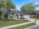 Lovely one-story home with manicured landscaping, mature trees and a spacious driveway leading to a convenient two-car garage at 4161 Leafy Glade Pl, Casselberry, FL 32707
