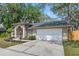 Attractive one-story home featuring a two-car garage, manicured lawn, and a welcoming facade with well-maintained landscaping at 4161 Leafy Glade Pl, Casselberry, FL 32707
