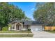 Stunning one-story home boasting lush landscaping, mature trees, and a spacious two-car garage, offering curb appeal and convenience at 4161 Leafy Glade Pl, Casselberry, FL 32707
