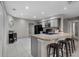 Open kitchen with counter seating, neutral cabinets, and modern appliances at 4161 Leafy Glade Pl, Casselberry, FL 32707