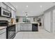 Modern kitchen with gray cabinets, stainless steel appliances, and an island at 4161 Leafy Glade Pl, Casselberry, FL 32707