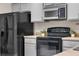 Modern kitchen featuring black appliances, gray cabinetry, and ample counter space at 4161 Leafy Glade Pl, Casselberry, FL 32707