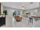 Bright living room with sliding glass doors to backyard, ceiling fan, and bar seating area at 4161 Leafy Glade Pl, Casselberry, FL 32707