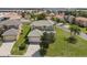 Aerial shot of a beautiful home with a three-car garage and well-manicured lawn at 426 Vista Loop, Davenport, FL 33897