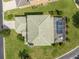 Aerial shot showing the tile roof and a screened in pool of a home with a beautiful yard at 426 Vista Loop, Davenport, FL 33897