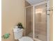 Well-lit bathroom featuring a glass-enclosed shower and toilet at 426 Vista Loop, Davenport, FL 33897
