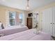 Bright bedroom with twin beds, chandelier, and an ensuite bathroom for added privacy and convenience at 426 Vista Loop, Davenport, FL 33897