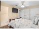 Spacious bedroom featuring a ceiling fan, a wall-mounted TV, and double door closets at 426 Vista Loop, Davenport, FL 33897