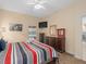 Cozy bedroom with striped bedding, a TV, dresser, and a sliding glass door to let in natural light at 426 Vista Loop, Davenport, FL 33897