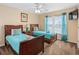 Comfortable bedroom with two twin beds, neutral walls, and a bright window with blue curtains at 426 Vista Loop, Davenport, FL 33897