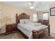 Cozy bedroom featuring a decorative wood frame bed, matching dressers, and a ceiling fan at 426 Vista Loop, Davenport, FL 33897