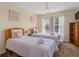 Charming bedroom with twin beds, decorative chandelier, and soft natural light for a restful retreat at 426 Vista Loop, Davenport, FL 33897