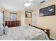 Bright bedroom with a ceiling fan, a large flat-screen TV, and a view of the entryway at 426 Vista Loop, Davenport, FL 33897