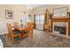 Cozy dining room with fireplace features a wooden table and views of the kitchen at 426 Vista Loop, Davenport, FL 33897