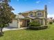 Charming home with a paver driveway, well-maintained landscaping and a tile roof at 426 Vista Loop, Davenport, FL 33897