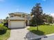 Stunning home with a beautiful paver driveway, lush landscaping and a tile roof at 426 Vista Loop, Davenport, FL 33897