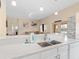 Modern kitchen with white cabinets and quartz countertops open to the living spaces at 426 Vista Loop, Davenport, FL 33897