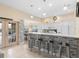 Modern kitchen with stone-accented bar, white cabinetry, and stainless steel appliances at 426 Vista Loop, Davenport, FL 33897