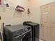 Functional laundry room with washer, dryer, shelving, and storage space for efficient chores at 426 Vista Loop, Davenport, FL 33897