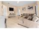 Spacious living room with tile flooring, comfortable sectional, and stylish decor at 426 Vista Loop, Davenport, FL 33897