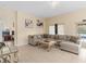 Comfortable living space with tile floors, a sectional sofa, and bright decor at 426 Vista Loop, Davenport, FL 33897