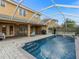 Backyard pool featuring a spa, brick-paved patio, and a screened-in enclosure at 426 Vista Loop, Davenport, FL 33897