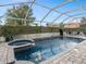 A covered outdoor pool and spa provide the perfect private, outdoor escape at 426 Vista Loop, Davenport, FL 33897