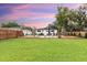 Inviting backyard with a sparkling pool, lounge chairs, and a lush green lawn perfect for relaxation and entertainment at 446 Piney Croft Ln, Maitland, FL 32751
