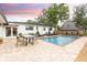 Beautiful backyard with a pool, fountains, and patio with seating at 446 Piney Croft Ln, Maitland, FL 32751